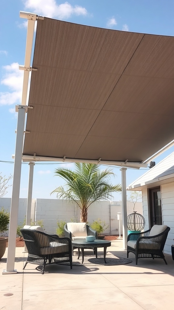 A modern shade structure with a fabric canopy and comfortable seating underneath, surrounded by greenery.